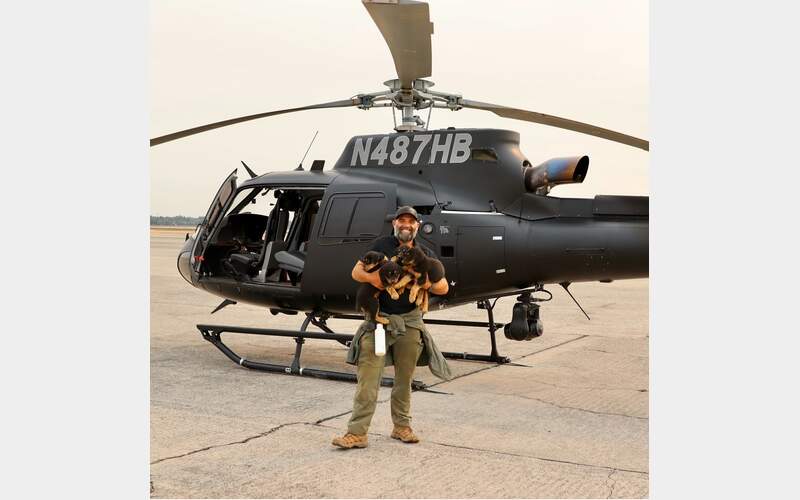 Determined to save stranded dogs and puppies, Trevor Skaggs, a member of the Butte County Sheriff’s Search and Rescue took to the skies in a helicopter